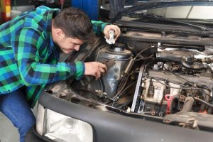 mechanic-repairing-car-auto-repair-shop